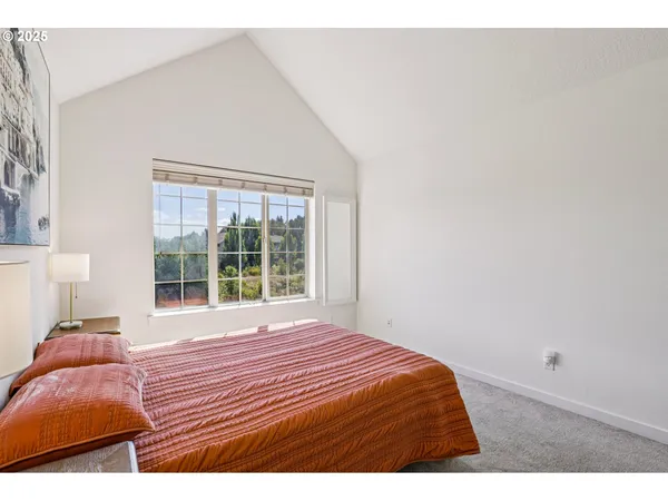 a bedroom with a bed and window