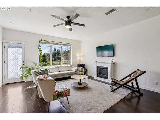 a living room with furniture a fireplace and a flat screen tv