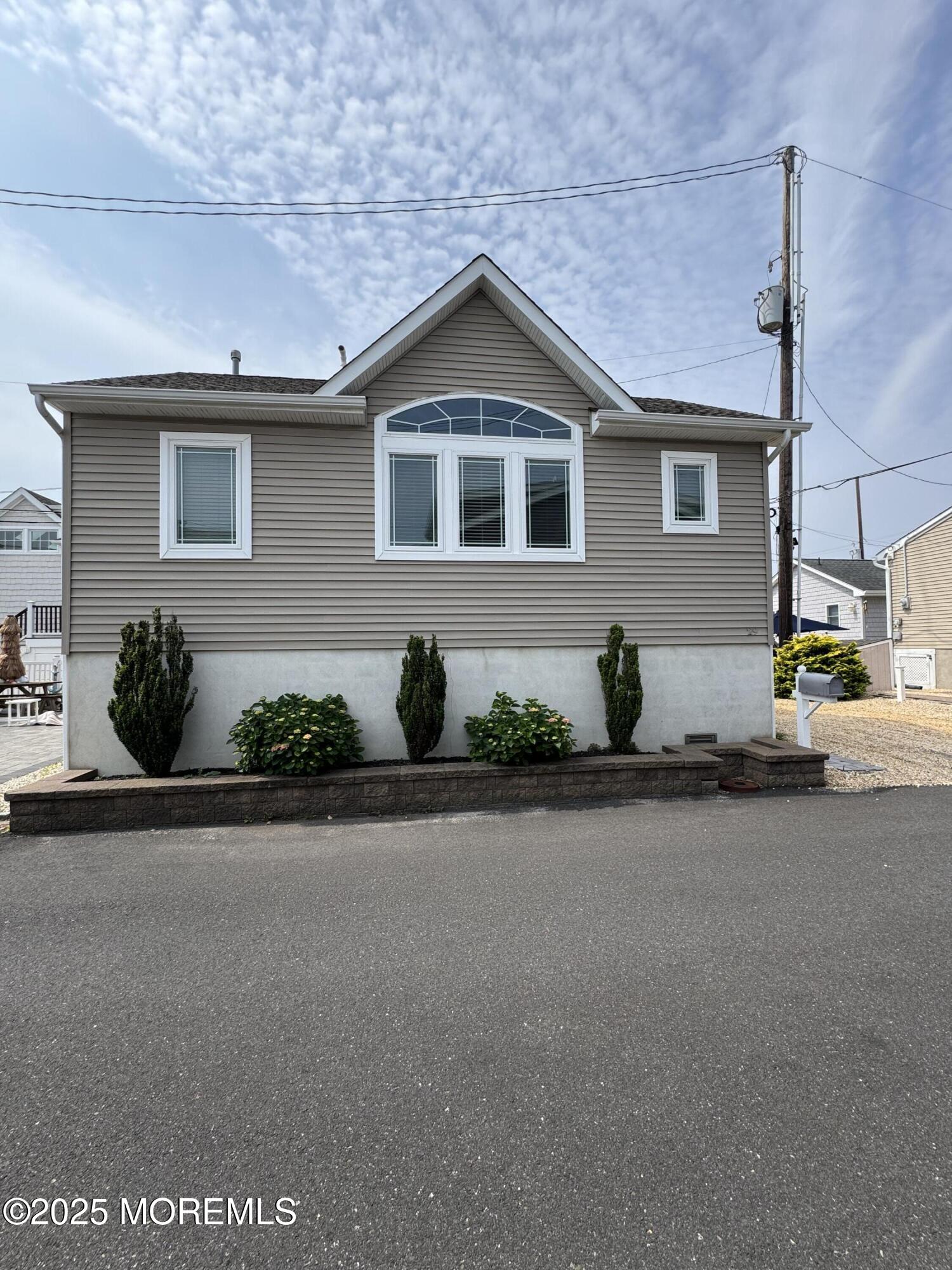 29 East Dune Way Lavallette, NJ 08735 - Photo 1 of 9 a front view of a house with a yard and garage