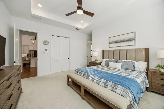 a spacious bedroom with a bed and a dresser