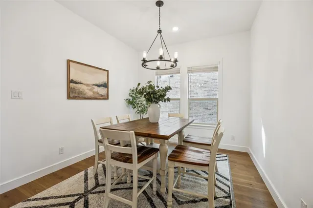 a view of a dining room with furniture wooden floor and a chandelier