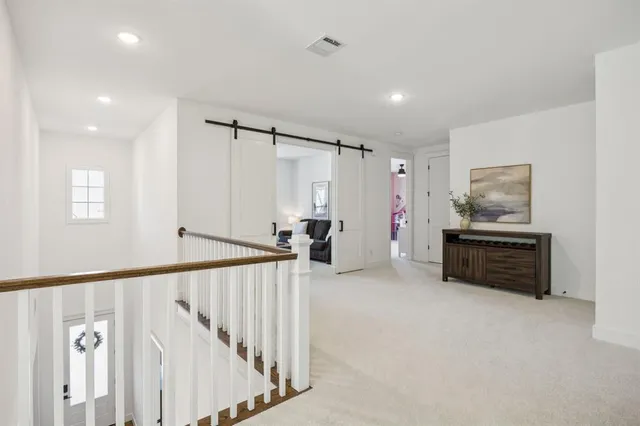 a view of hallway with stairs and furniture