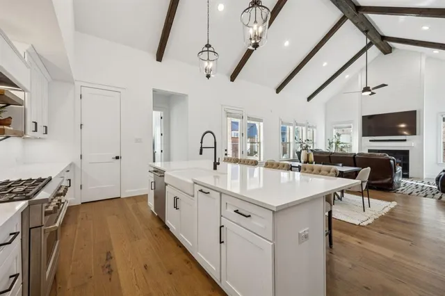 a large white kitchen with a large window