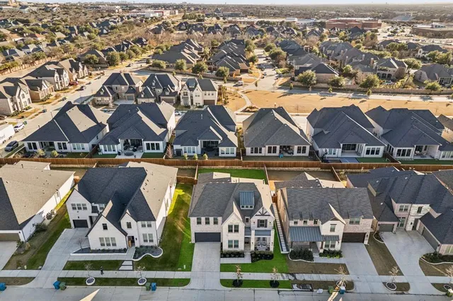 an aerial view of houses with trees