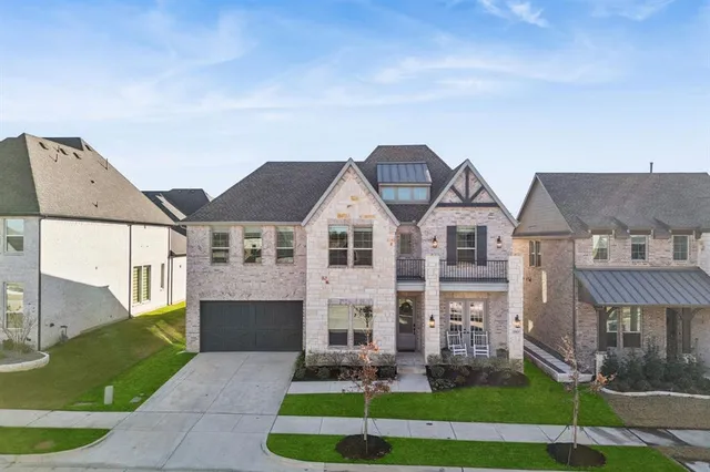 a front view of residential houses with yard and green space