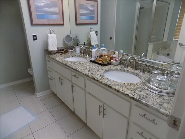 a bathroom with double sink and a mirror