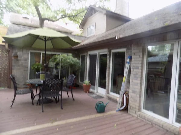 a view of a patio with table and chairs under an umbrella