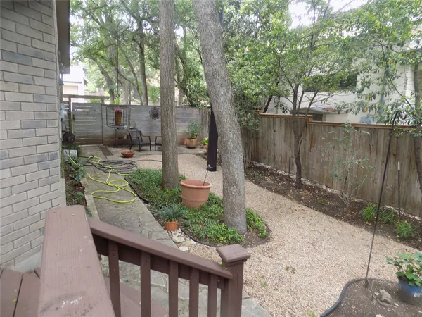 a view of a backyard with wooden fence