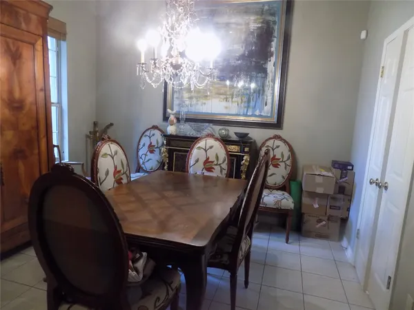 a dining room with furniture and chandelier