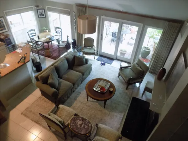 a living room with furniture and a floor to ceiling window