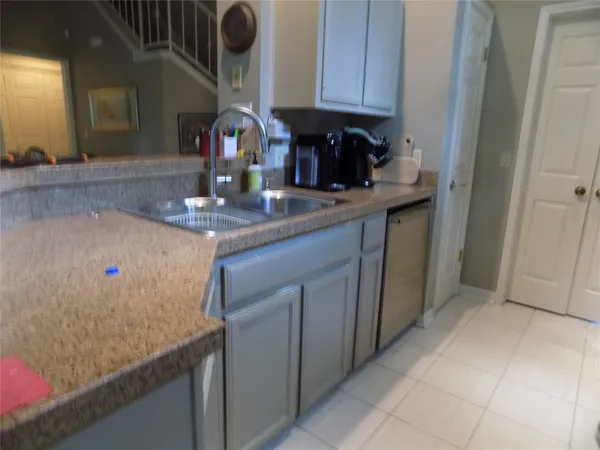 a kitchen with stainless steel appliances granite countertop a sink and cabinets