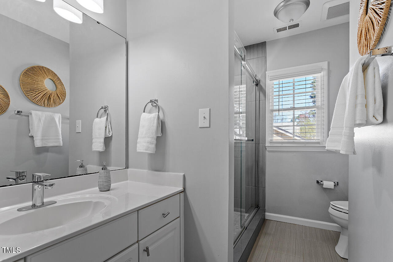 9004 Admaston Drive Raleigh, NC 27613 - Photo 25 of 30 A full bath is located convenient to the other 3 bedrooms.