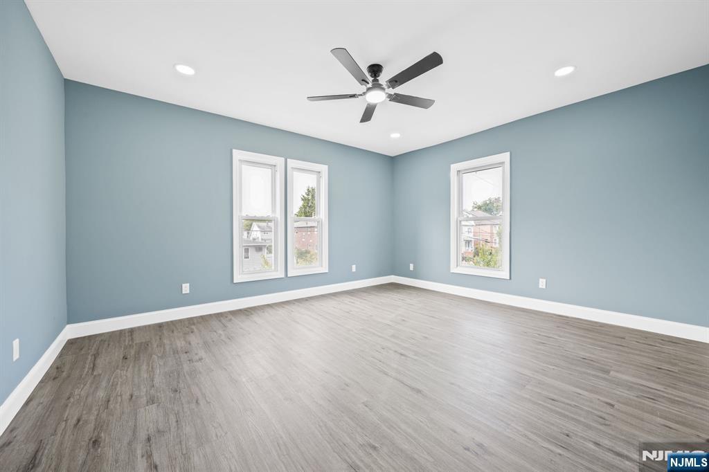137 Prospect Place Rutherford, NJ 07070 - Photo 12 of 19 an empty room with wooden floor window and ceiling fan