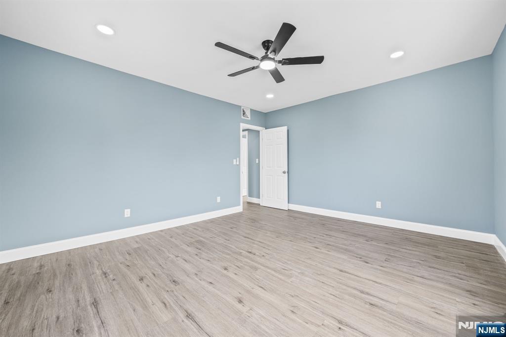 137 Prospect Place Rutherford, NJ 07070 - Photo 13 of 19 a view of an empty room with wooden floor and a ceiling fan