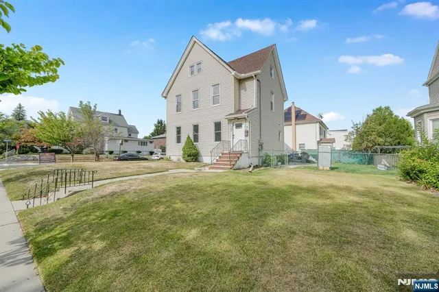 a view of a house with a yard and a fountain