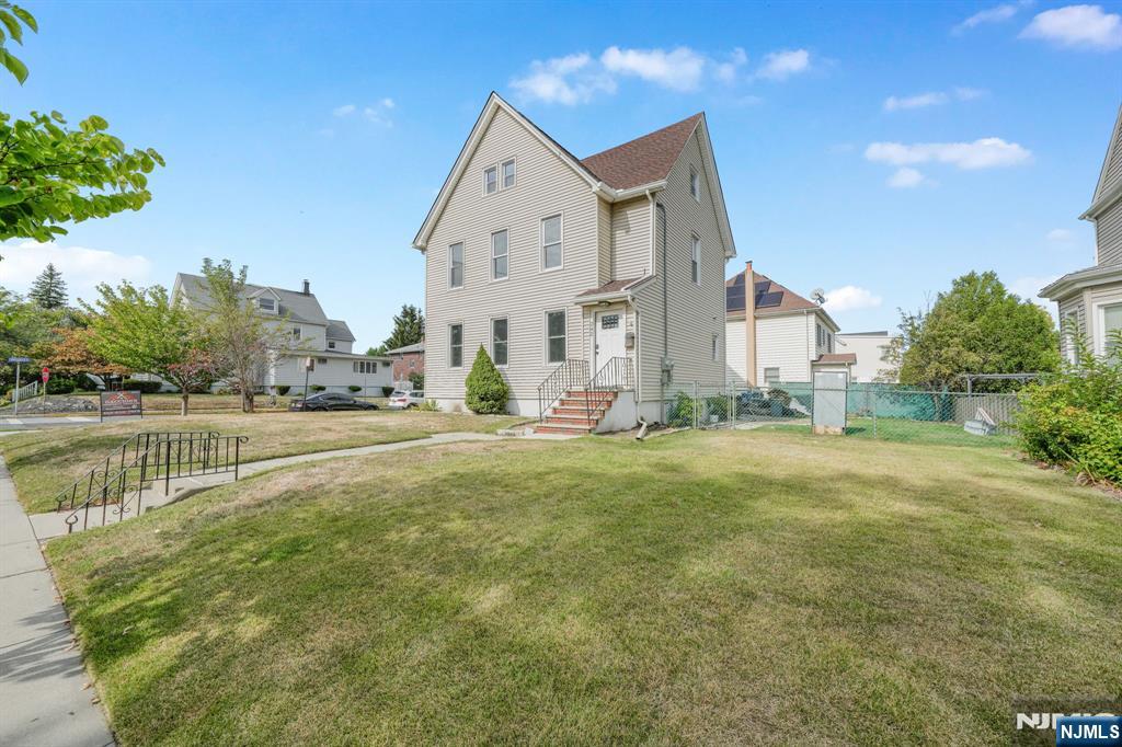 137 Prospect Place Rutherford, NJ 07070 - Photo 3 of 19 a view of a house with a yard and a fountain