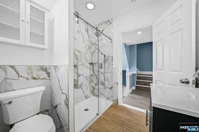 a bathroom with a sink toilet and shower