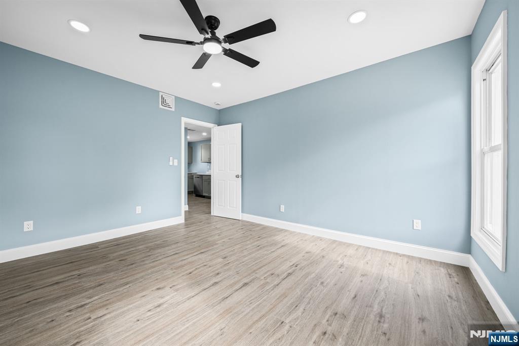 137 Prospect Place Rutherford, NJ 07070 - Photo 10 of 19 an empty room with wooden floor and windows