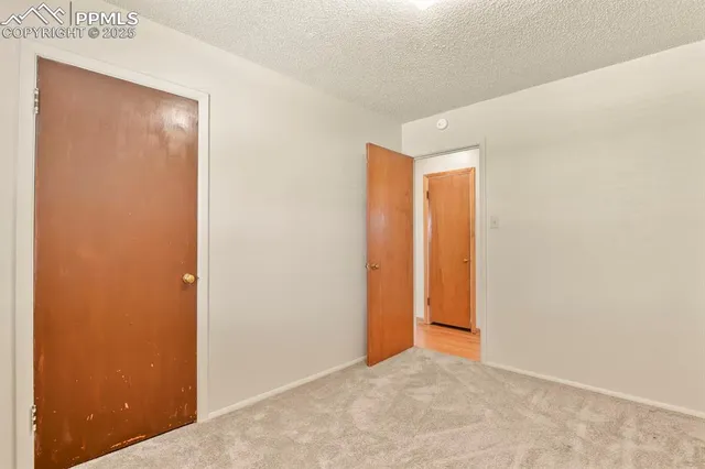 a view of a patio with table and chairs potted plants and palm tree