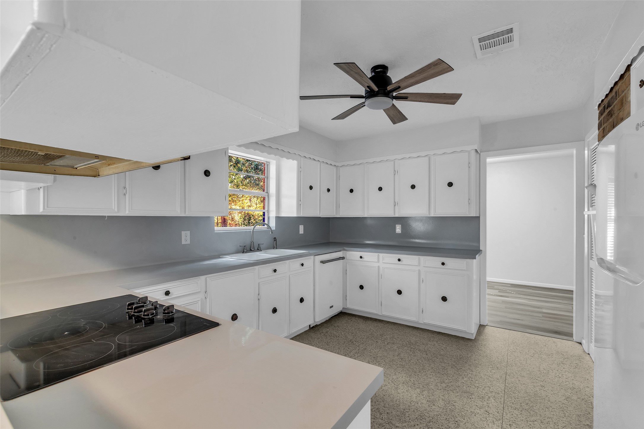 23311 Nichols Sawmill Road Hockley, TX 77447 - Photo 5 of 23 a kitchen with granite countertop white cabinets and window