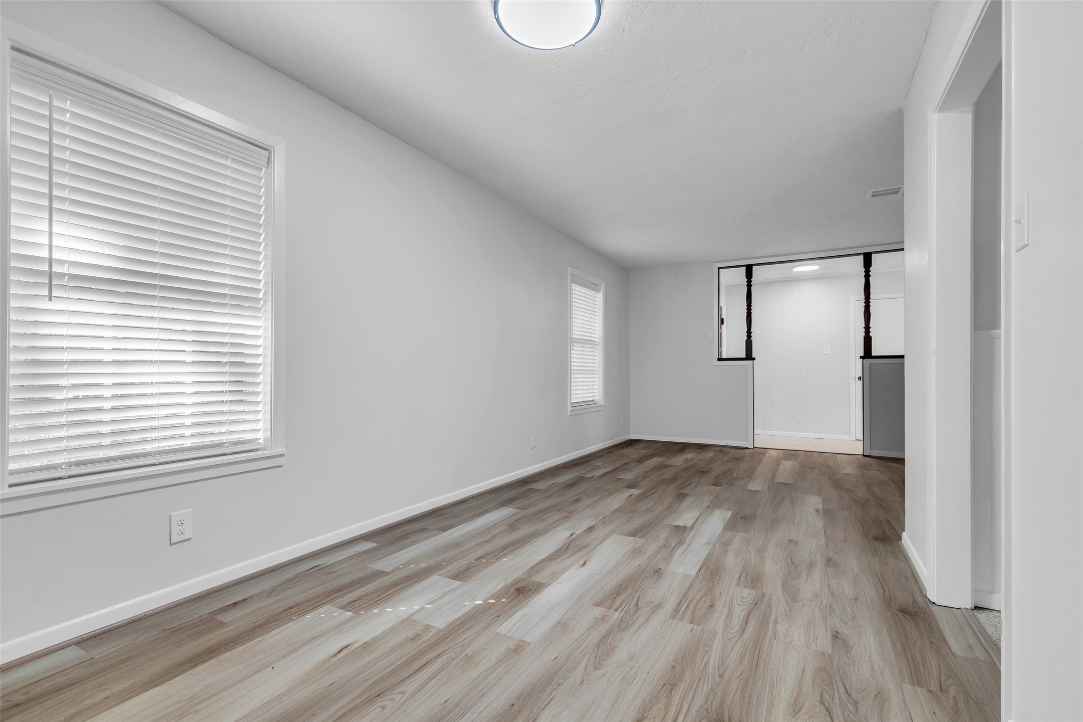 23311 Nichols Sawmill Road Hockley, TX 77447 - Photo 10 of 23 a view of an empty room with wooden floor and a window