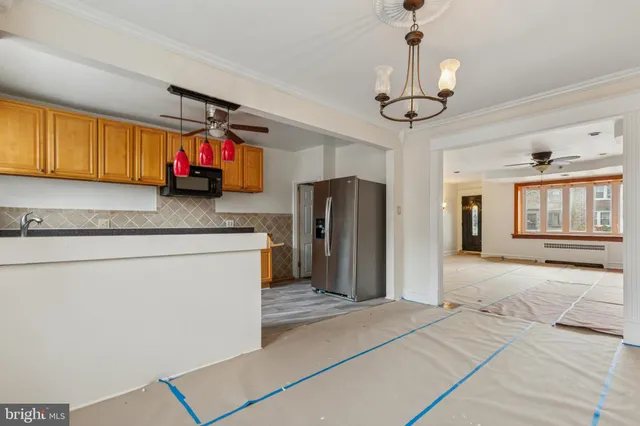 a kitchen with stainless steel appliances granite countertop a refrigerator and microwave
