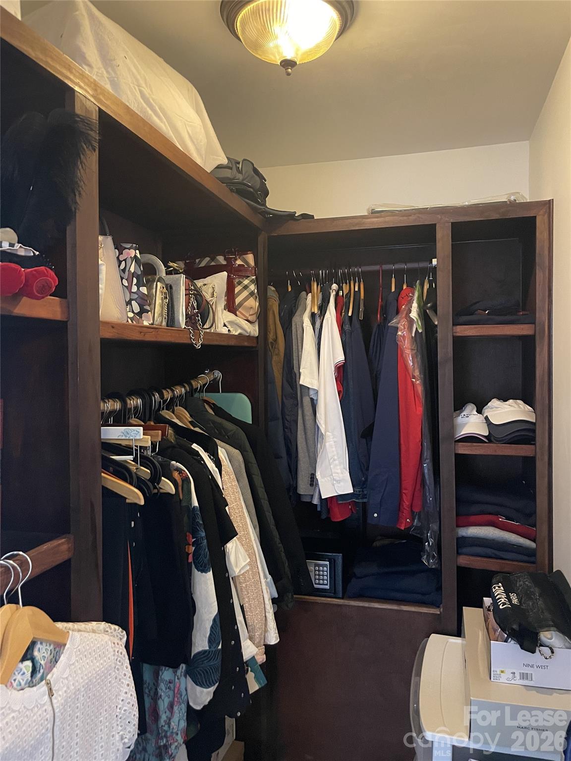 3800 Oldfield Road Charlotte, NC 28226 - Photo 18 of 32 a view of walk in closet with clothes and shoes