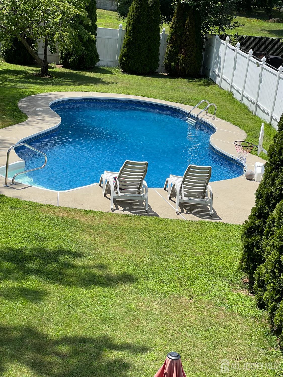 105 Howard Avenue Edison, NJ 08837 - Photo 11 of 39 a view of a swimming pool with a yard