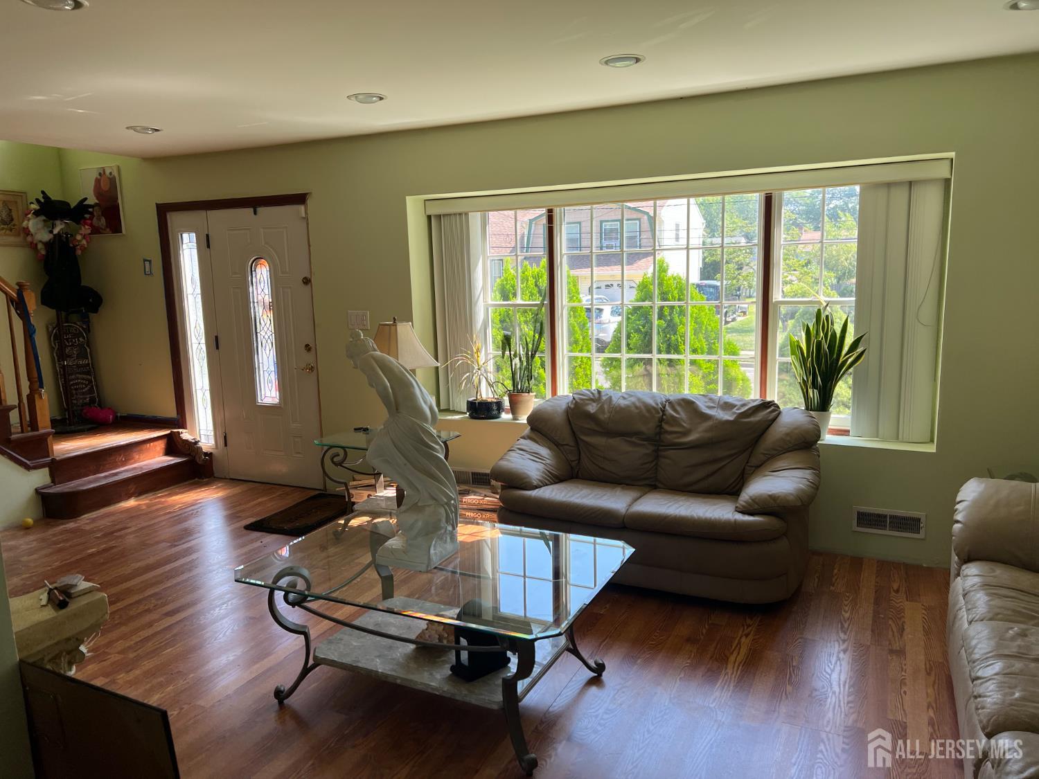 105 Howard Avenue Edison, NJ 08837 - Photo 12 of 39 a living room with furniture gym equipment and a large window