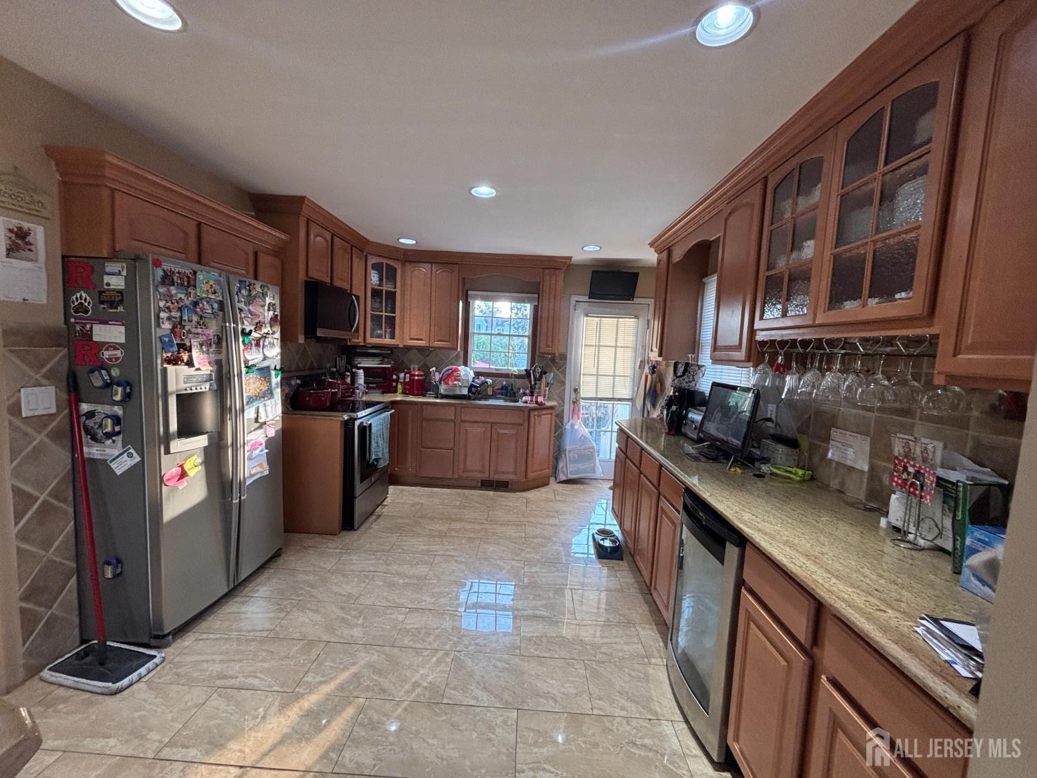 105 Howard Avenue Edison, NJ 08837 - Photo 18 of 39 a kitchen with stainless steel appliances granite countertop a refrigerator a stove top oven a sink and dishwasher