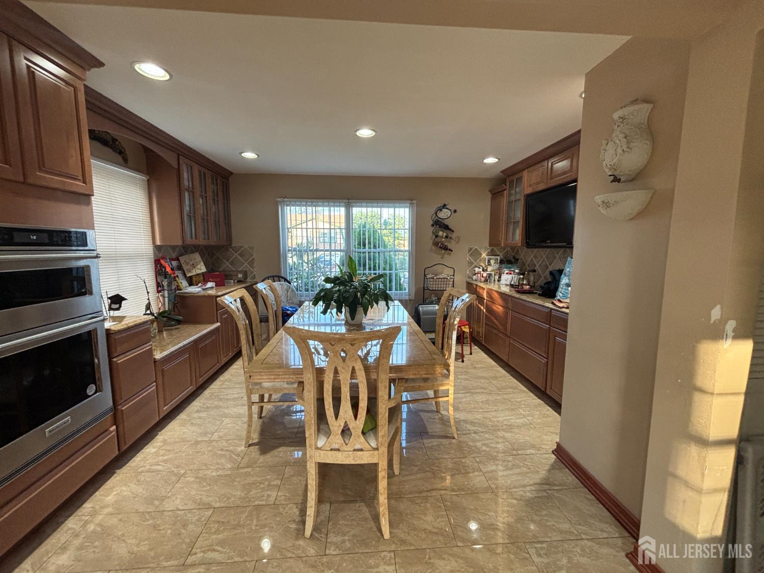 105 Howard Avenue Edison, NJ 08837 - Photo 20 of 39 a kitchen with a table chairs refrigerator and microwave