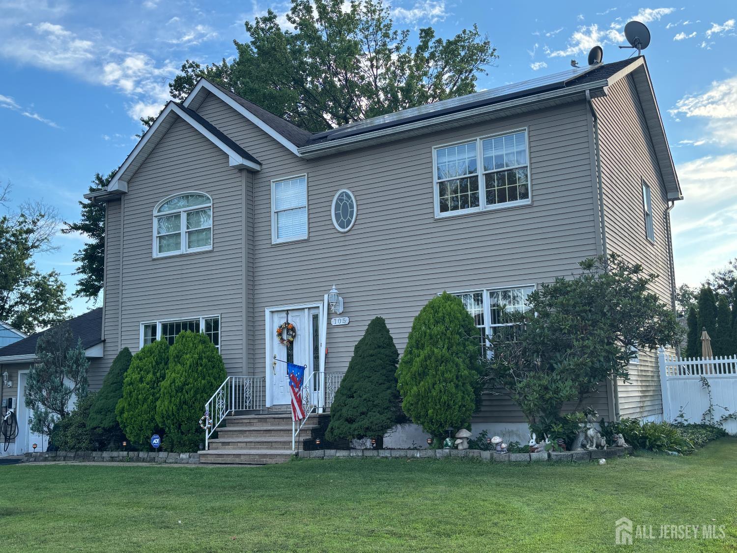 105 Howard Avenue Edison, NJ 08837 - Photo 2 of 39 a front view of house with a garden