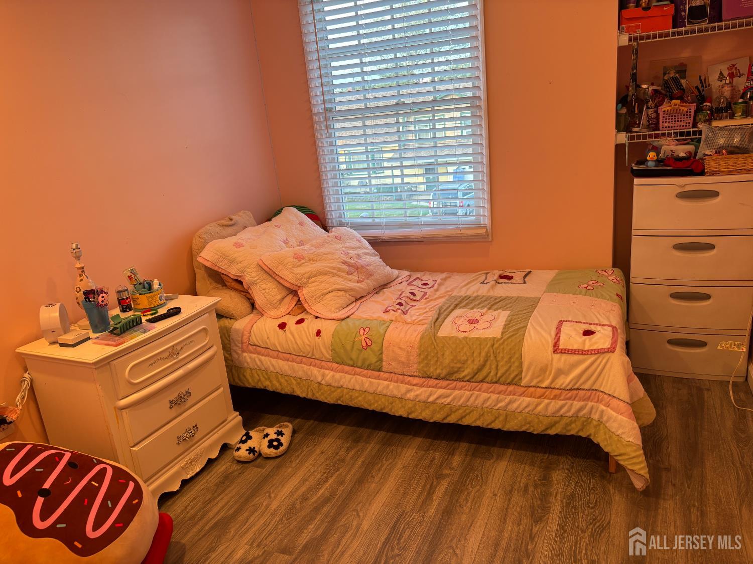 105 Howard Avenue Edison, NJ 08837 - Photo 24 of 39 a bedroom with a bed and wooden floor