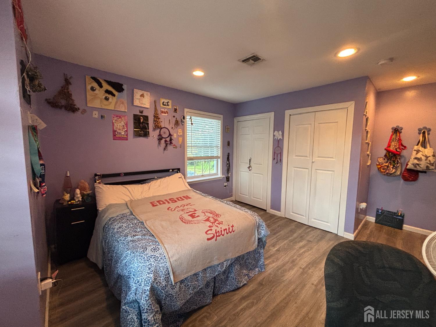 105 Howard Avenue Edison, NJ 08837 - Photo 27 of 39 a spacious bedroom with a bed and a couch
