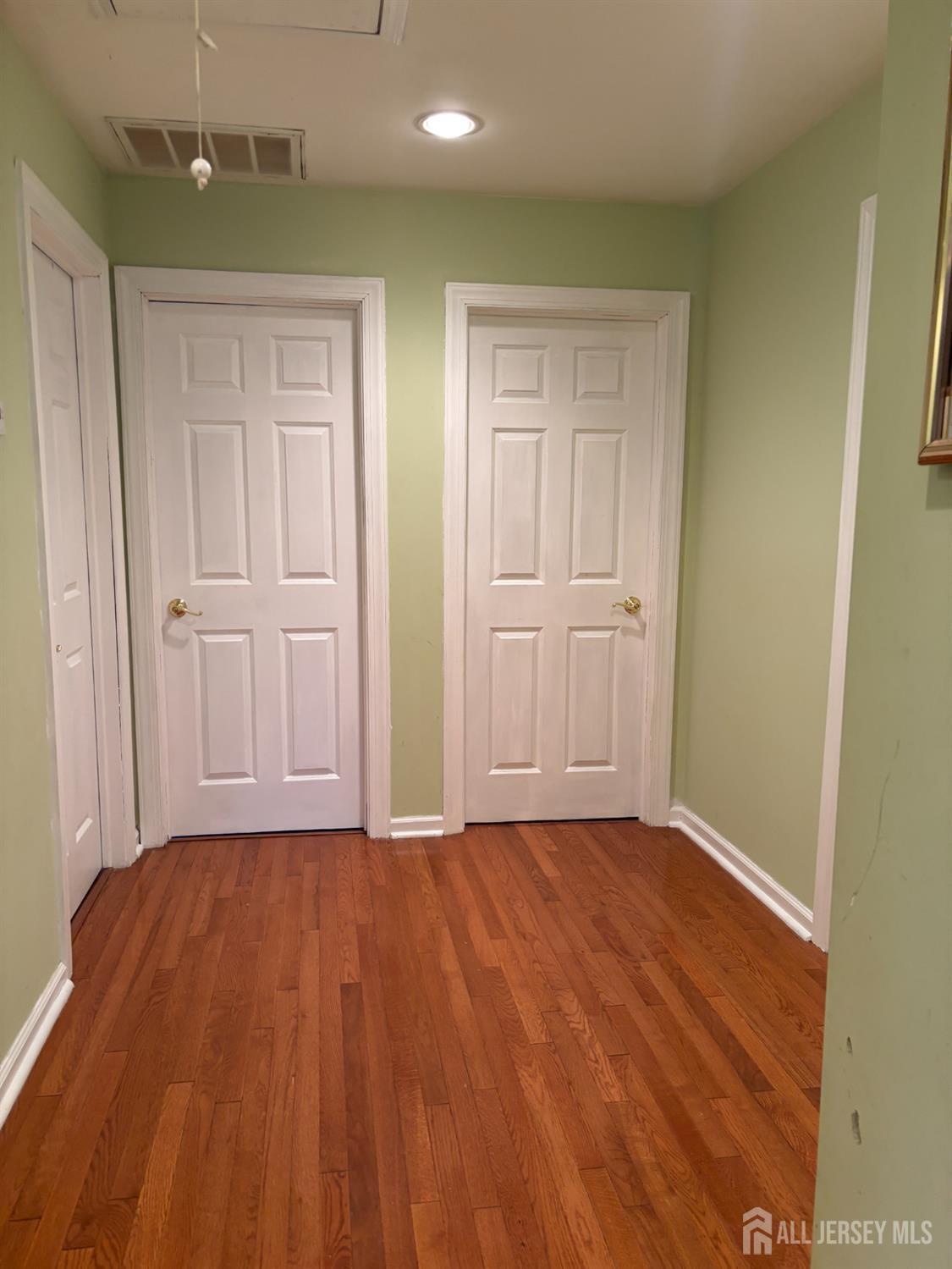 105 Howard Avenue Edison, NJ 08837 - Photo 33 of 39 a view of an empty room and wooden floor