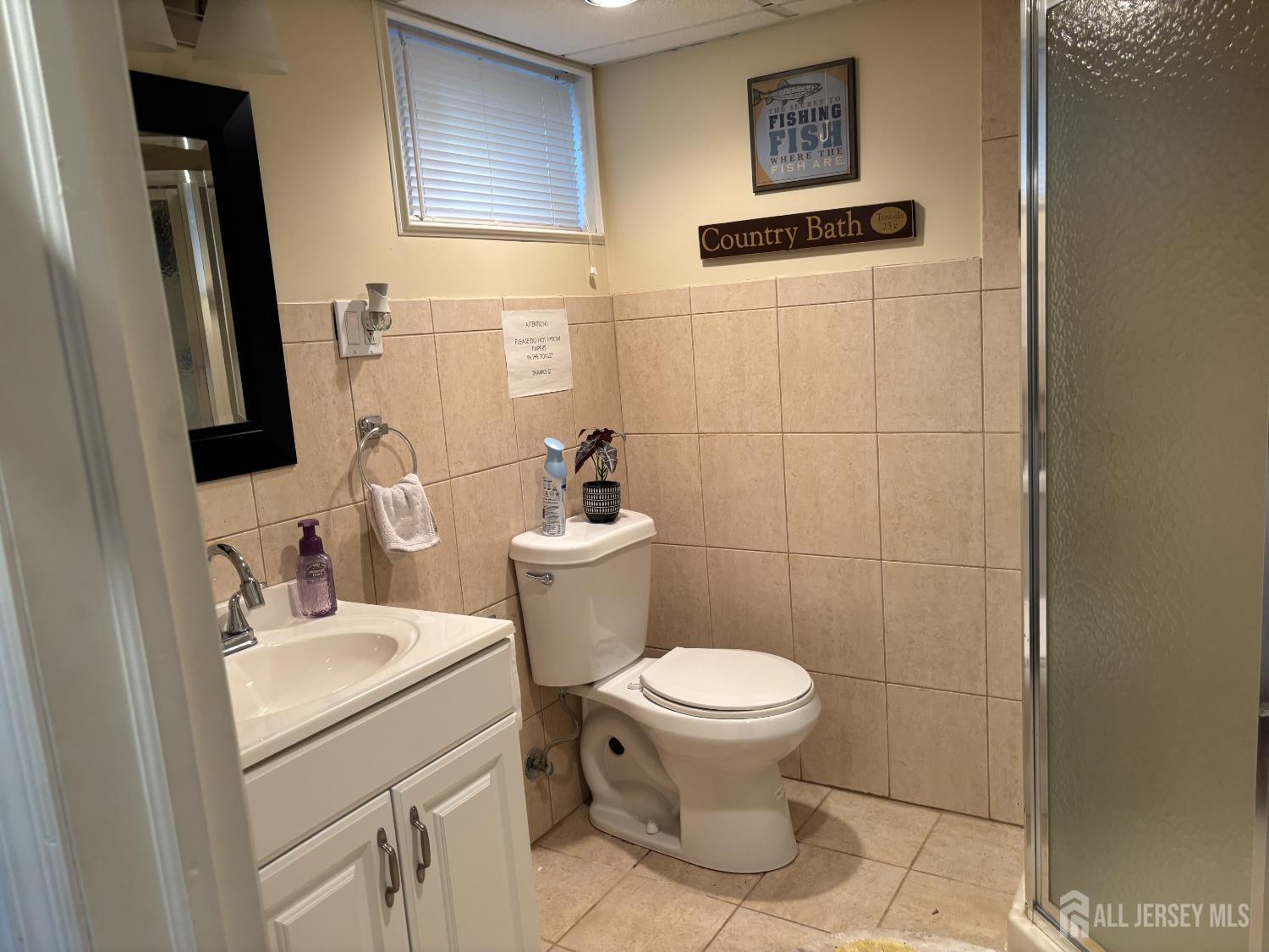 105 Howard Avenue Edison, NJ 08837 - Photo 38 of 39 a bathroom with a sink toilet and a mirror