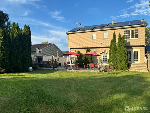 a view of a house with backyard and porch