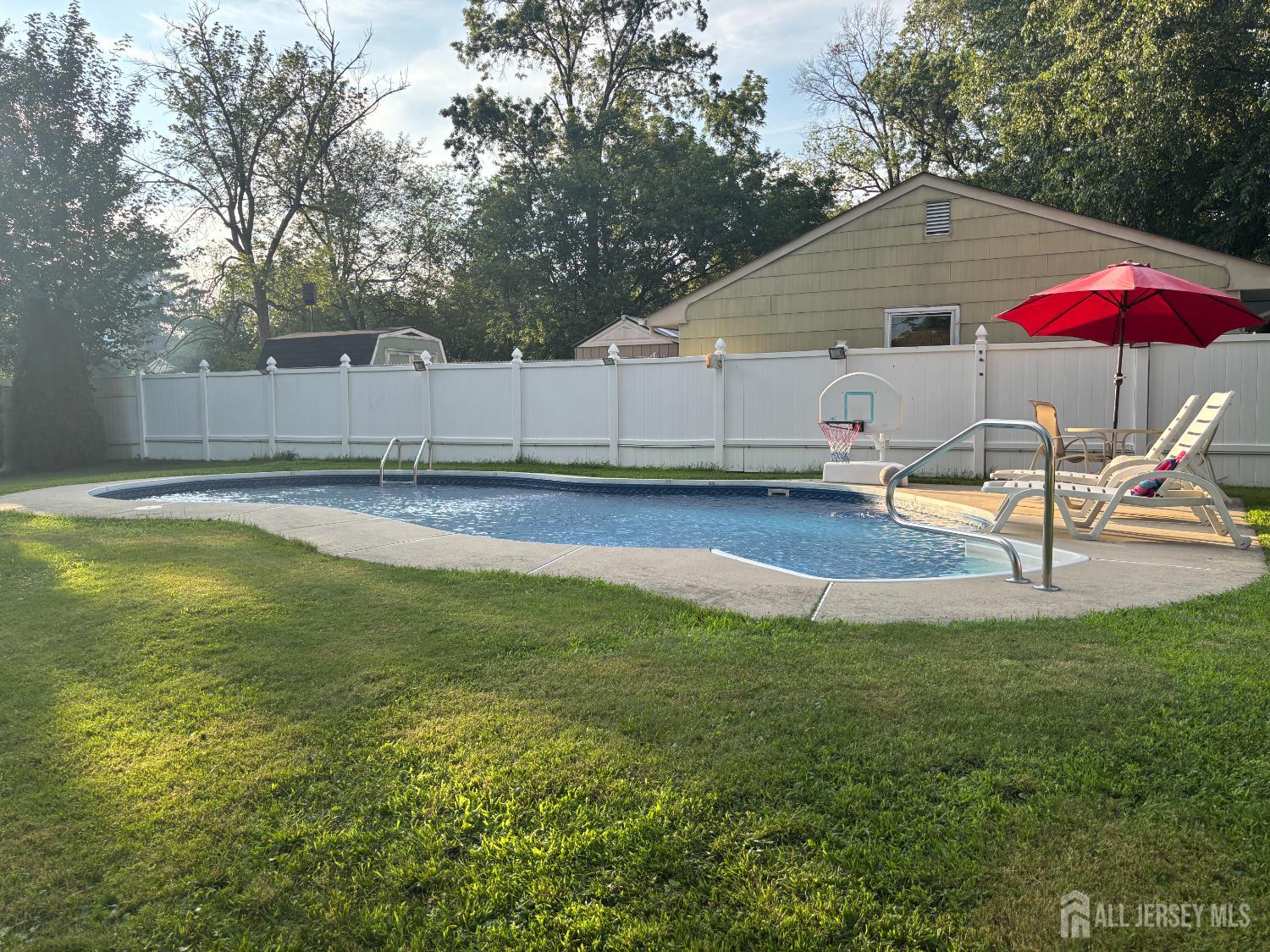 105 Howard Avenue Edison, NJ 08837 - Photo 6 of 39 a view of a swimming pool with lounge chairs