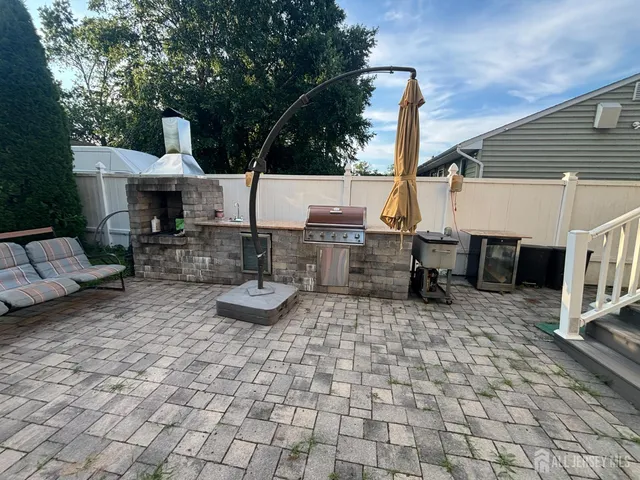 a view of a patio with chairs and potted plants