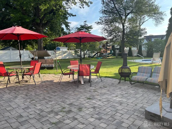 an outdoor sitting area with chairs and umbrellas