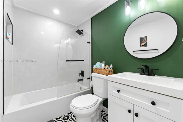a bathroom with a sink mirror toilet and bathtub