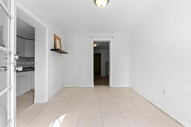 a view of an empty room with kitchen