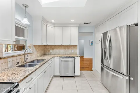 a kitchen with a sink appliances and cabinets