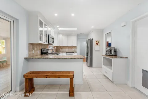 a kitchen with stainless steel appliances granite countertop a refrigerator and a stove top oven