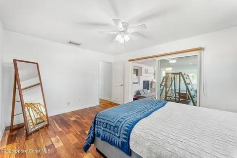 a bedroom with a bed and a mirror