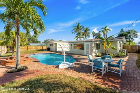 a view of a house with backyard porch and sitting area