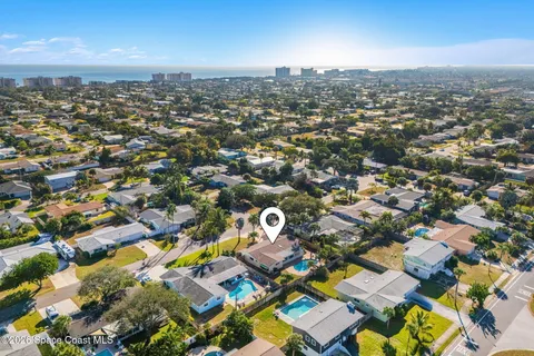 an aerial view of residential building with yard