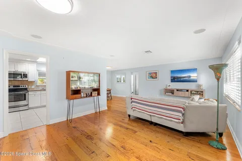 a spacious bedroom with a bed and a flat screen tv