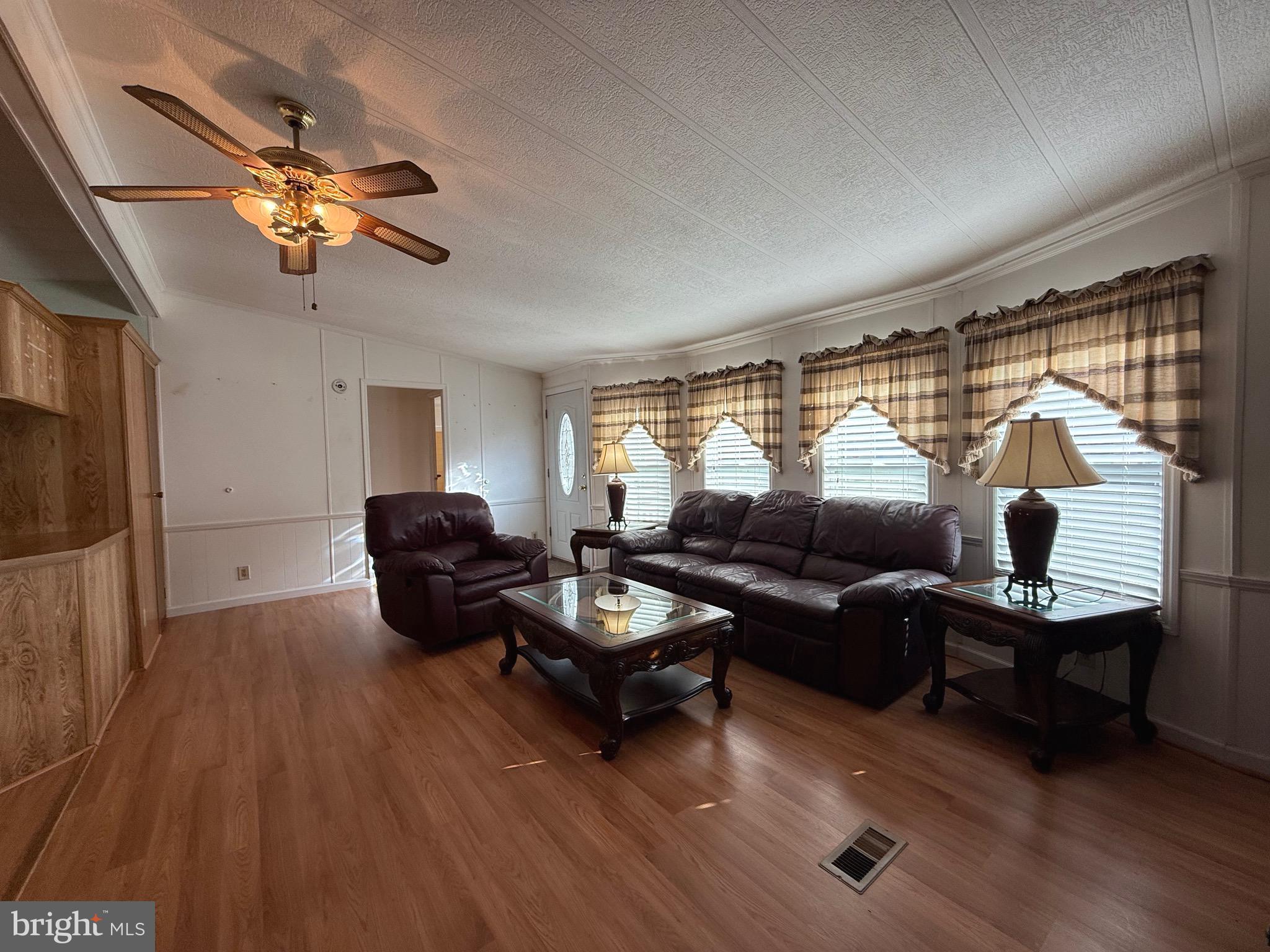 386 Indian Way Buena, NJ 08310 - Photo 24 of 53 a living room with furniture a window and a flat screen tv