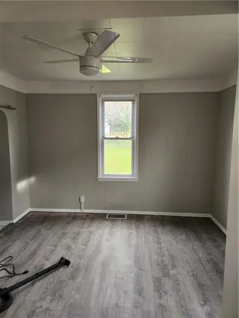 a room with wooden floor and a sink